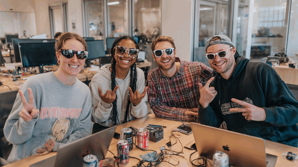 Creative publishing team celebrating after successfully blending AI efficiency with human storytelling